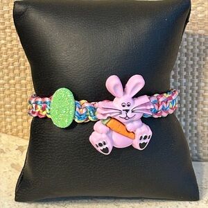 Pink Easter Bunny and sparkling egg on confetti background; adjustable bracelet